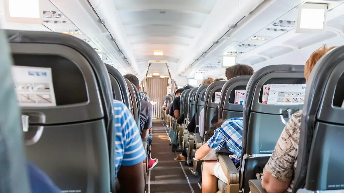 Geneve, Switzerland - August, 22nd 2014: Anxious passengers seen from behind inside a Swiss airliner taking off from Geneve airport. An Airbus 319 jet, about to embark.