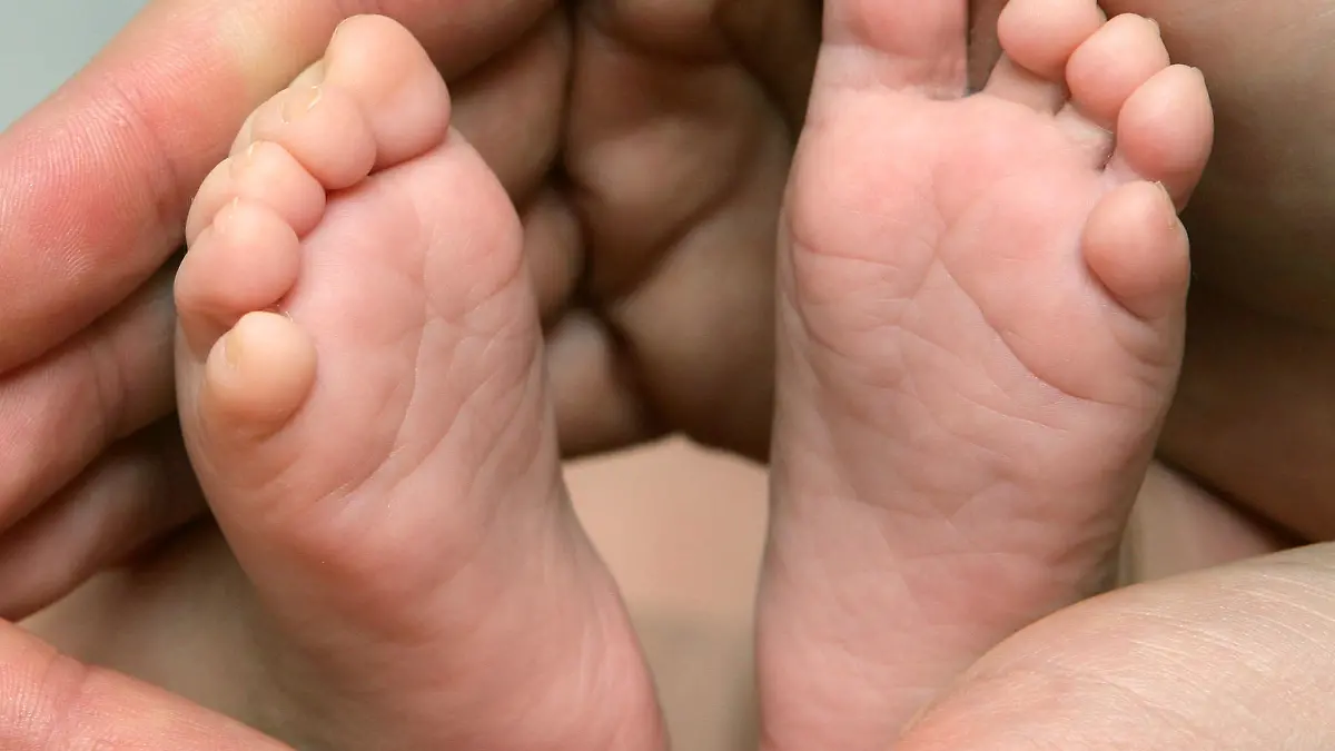 ARCHIV - Die winzigen Füße eines neun Wochen alten Babys zwischen den Händen seiner Mutter (Archivfoto vom 13.12.2006). Das Bundesfinanzministerium hat ein Veto gegen die Pläne der Familienministerin eingelegt, das Betreuungsgeld bereits jetzt gesetzlich festzuschreiben. Die entsprechende Passage müsse aus dem Gesetzentwurf entfernt werden, sagte ein Ministeriumssprecher. Foto: Patrick Pleul +++(c) dpa - Bildfunk+++