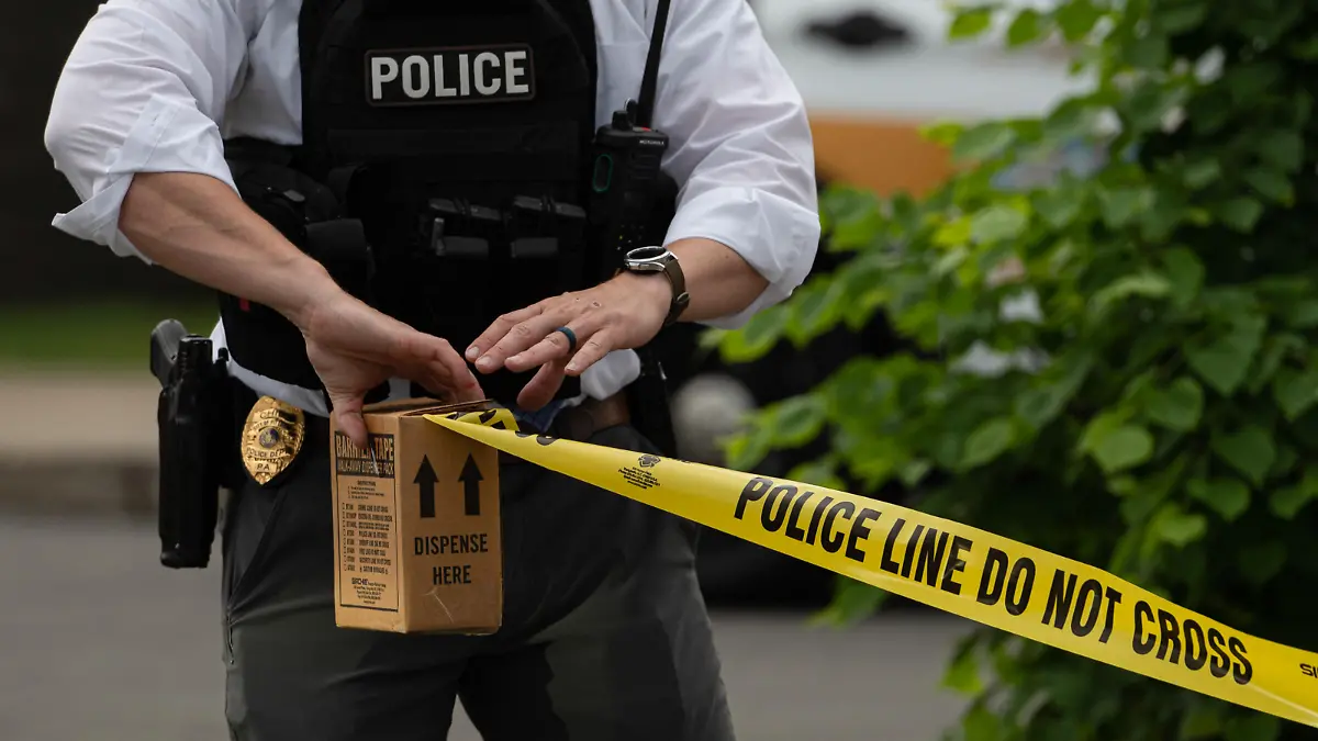 June 1, 2022, Pittston, United States: A police officer pulls police tape after a shooting in a nail salon. Reports of an active shooter in a Walmart turned into a shooting in an adjacent Nail Salon. The reports brought out law enforcement from multiple counties, State Police and Homeland Security. The shooter fired inside the salon striking one woman and then fled the scene where police searched for him. (Credit Image: © Aimee Dilger/SOPA Images via ZUMA Press Wire
