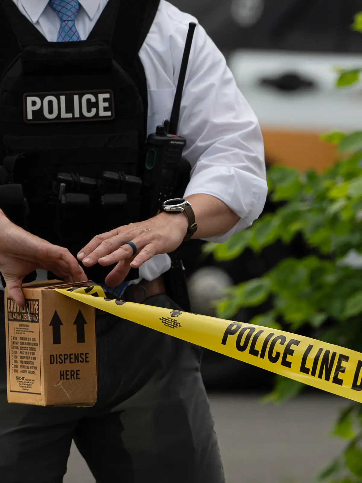 June 1, 2022, Pittston, United States: A police officer pulls police tape after a shooting in a nail salon. Reports of an active shooter in a Walmart turned into a shooting in an adjacent Nail Salon. The reports brought out law enforcement from multiple counties, State Police and Homeland Security. The shooter fired inside the salon striking one woman and then fled the scene where police searched for him. (Credit Image: © Aimee Dilger/SOPA Images via ZUMA Press Wire