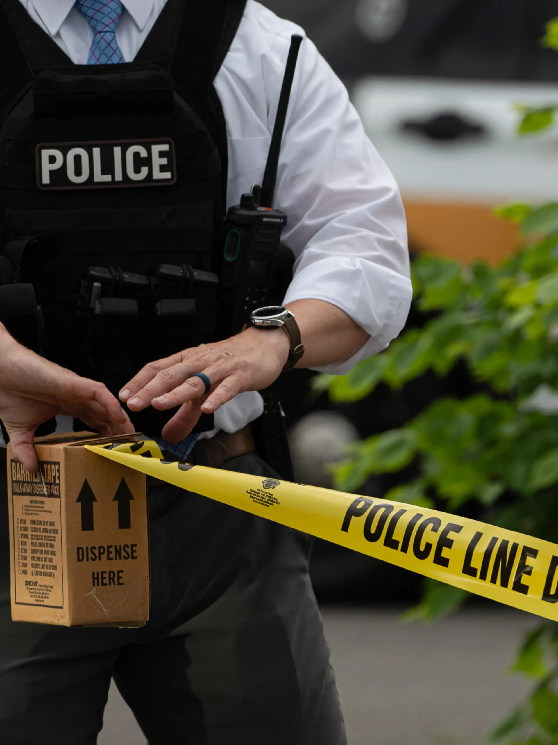 June 1, 2022, Pittston, United States: A police officer pulls police tape after a shooting in a nail salon. Reports of an active shooter in a Walmart turned into a shooting in an adjacent Nail Salon. The reports brought out law enforcement from multiple counties, State Police and Homeland Security. The shooter fired inside the salon striking one woman and then fled the scene where police searched for him. (Credit Image: © Aimee Dilger/SOPA Images via ZUMA Press Wire