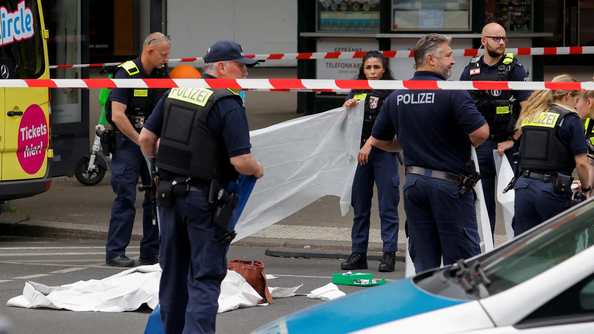 Police officers work next to the body of a victim at the scene where a car crashed into a group of people near Breitscheidplatz in Berlin, Germany, June 8, 2022. REUTERS/Michele Tantussi