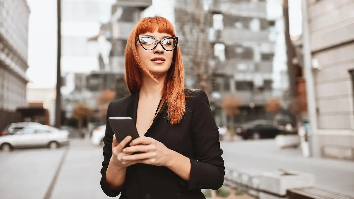 Elegant Businesswoman Arranging Meeting On Smartphone While Walking In City