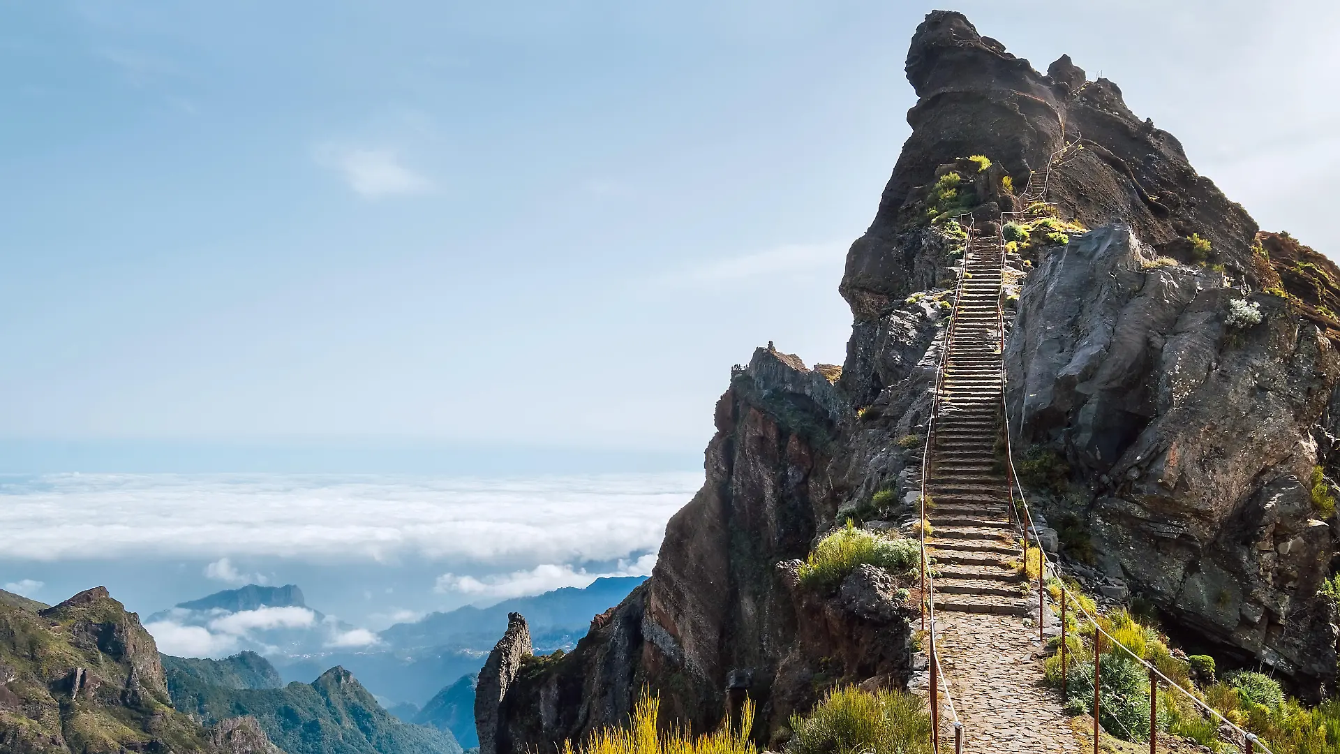 "Stairs to heaven" - Breathtaking view at famous mountain footpath from Pico do Arieiro to Pico Ruivo on the Portuguese Madeira island. Trekking Around the world traveling with kids concept image.