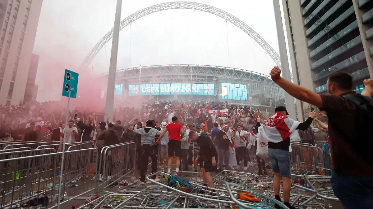 FILE PHOTO: Soccer Football - Euro 2020 - Final - Fans gather for Italy v England - Wembley Stadium, London, Britain - July 11, 2021 Picture taken July 11, 2021 England fans celebrate outside Wembley Stadium during the match Action Images via Reuters/Lee Smith/File Photo