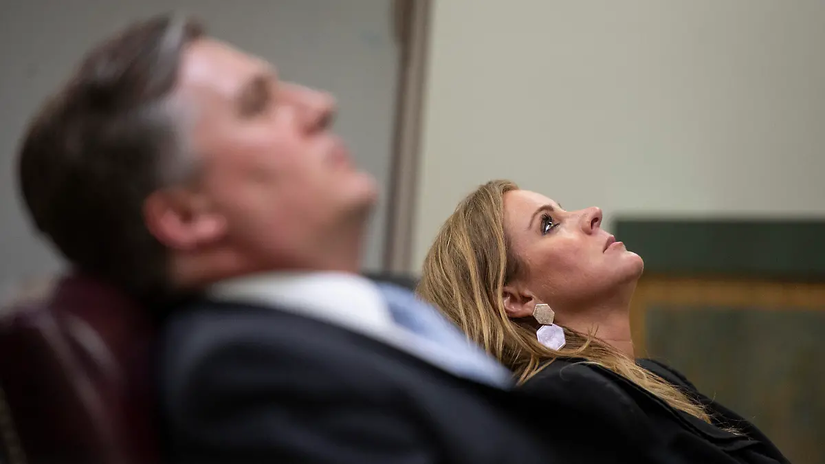 Prosecuting attorneys District Attorney Angel Myers McIlrath, right, and Assistant District Attorney Justin Lovorn lean back in their chairs as Jacob Blair Scott rambles while answering a question as he testifies during his trial for sexual abuse on Wednesday, June 1, 2022, in Pascagoula, Miss. Scott, a military veteran who once faked his own death to try to avoid criminal charges, was convicted Thursday, June 2, 2022,  of sexually assaulting a girl and impregnating her when he was 40 and she was 14. (Hannah Ruhoff/The Sun Herald via AP)
