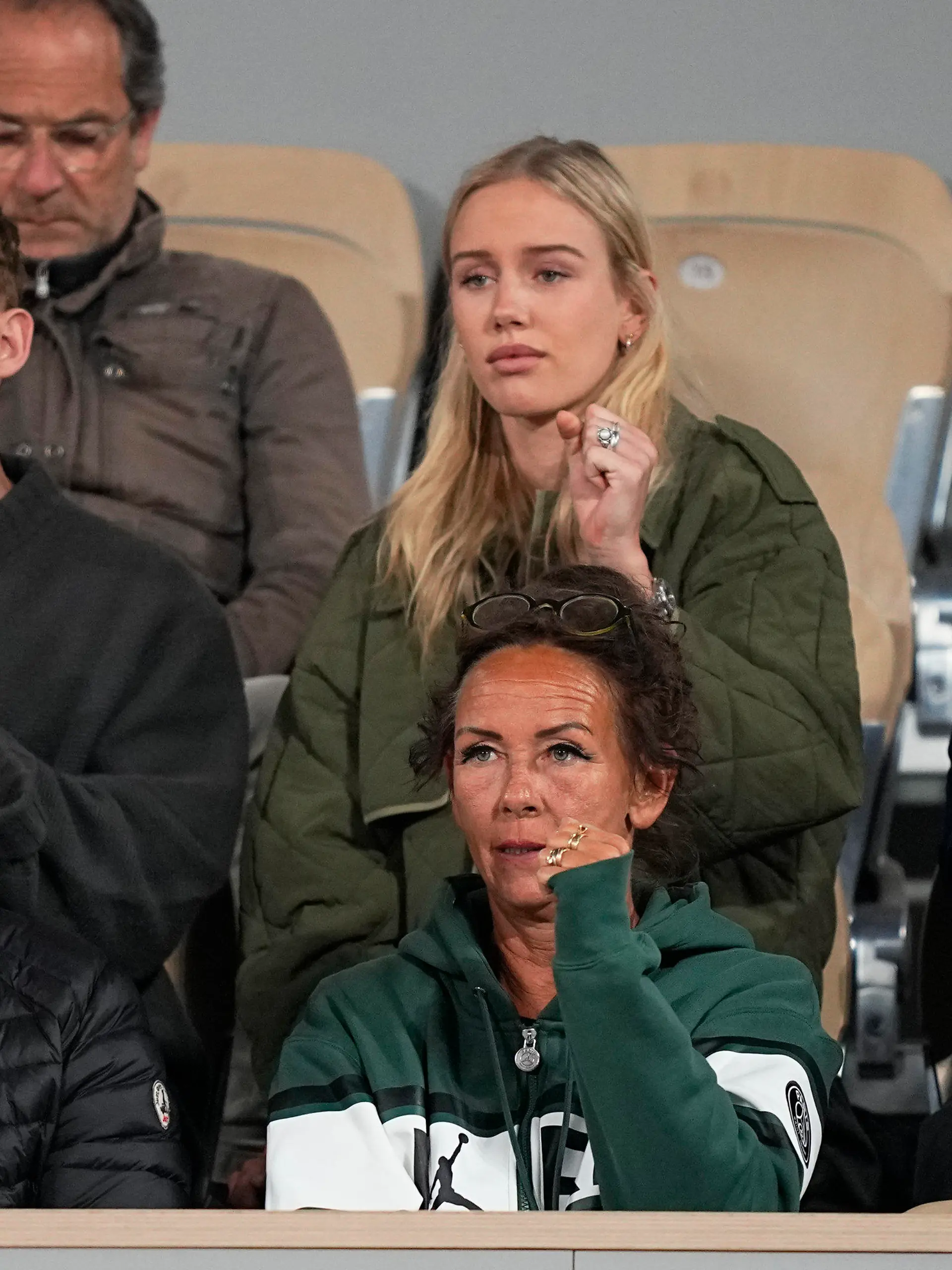 Denmark's Holger Rune's mother Aneke, bottom center, his sister Alma, top center, and coach Lars Christensen. bottom left, watch the quarterfinal match against Norway's Casper Ruud at the French Open tennis tournament in Roland Garros stadium in Paris, France, Wednesday, June 1, 2022. (AP Photo/Michel Euler)