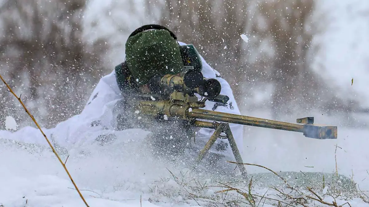 In this photo released by the Russian Defense Ministry Press Service on Tuesday, Feb. 1, 2022, A sniper fires during a military exercise in the Nizhny Novgorod Region, Russia. (Russian Defense Ministry Press Service via AP)
