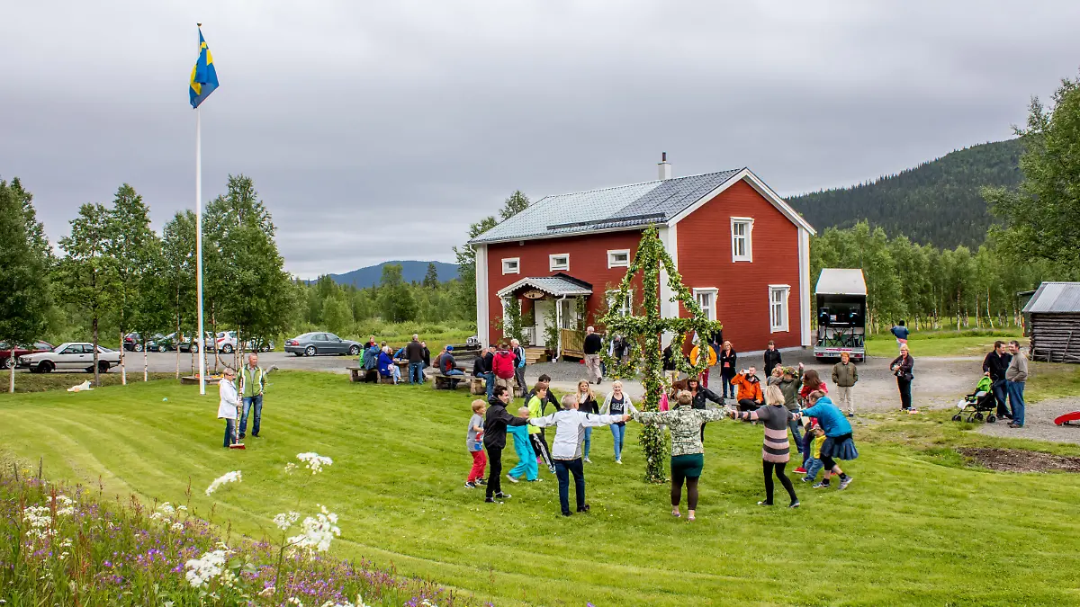Lappland, Kittelfjaell, Sweden: - June 21, 2013: Locals are celebrating midsummer in a small village on its community centre lawn