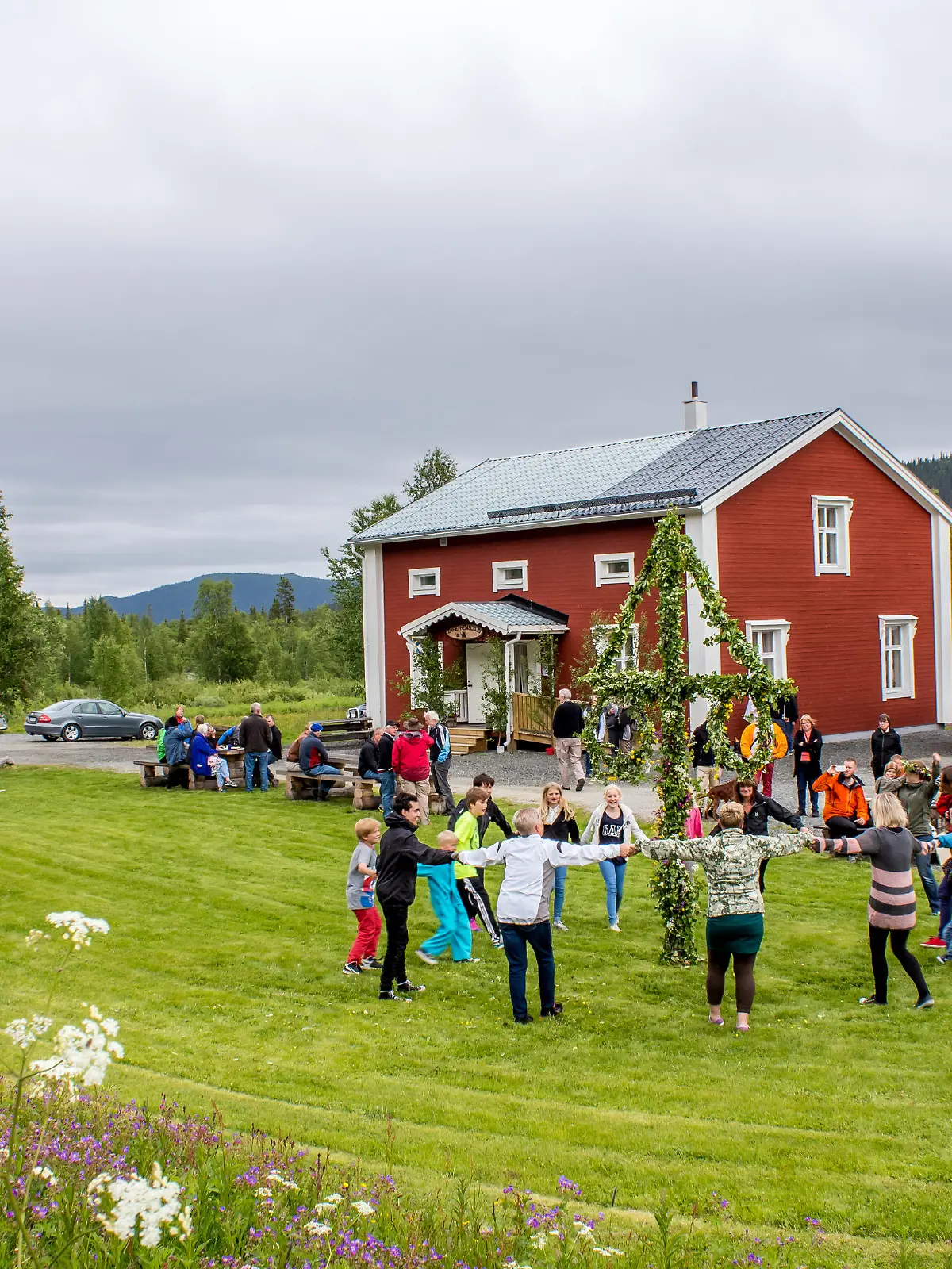 Lappland, Kittelfjaell, Sweden: - June 21, 2013: Locals are celebrating midsummer in a small village on its community centre lawn