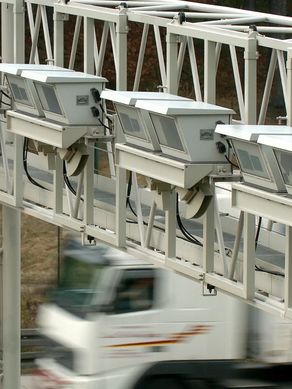ARCHIV - Ein Lastwagen fährt auf der Autobahn bei Bad Klosterlausnitz unter einer Maut-Brücke mit Kontrollgeräten durch (Archivfoto vom 07.01.2005). Bis Ende 2006 wird die LKW-Maut den öffentlichen Kassen mehr als drei Milliarden Euro einbringen und damit die im Bundeshaushalt erwarteten Einnahmen von 2,9 Milliarden übertreffen. Foto: Jan-Peter Kasper dpa (zu dpa 0308 vom 18.12.2006) +++(c) dpa - Bildfunk+++