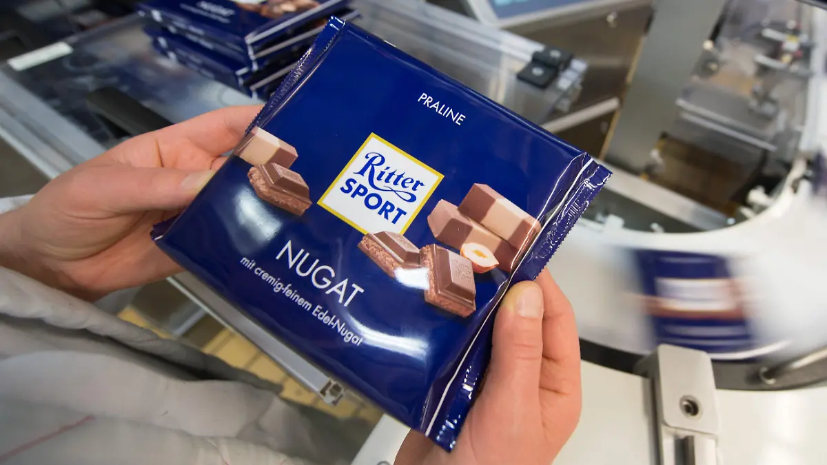 ARCHIV - 16.04.2015, Baden-Württemberg, Waldenbuch: Eine Mitarbeiterin des Schokoladenherstellers Ritter Sport prüft die Verpackung einer Tafel Schokolade. Auch 100 Tage nach Russlands Angriff auf die Ukraine bleiben zahlreiche deutsche Firmen in Russland aktiv. (zu dpa «Darum bleiben einige deutsche Firmen trotz Kritik in Russland») Foto: picture alliance / Marijan Murat/dpa +++ dpa-Bildfunk +++