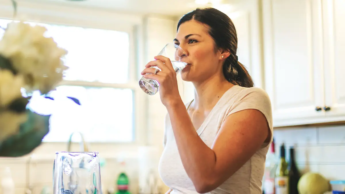 Beautiful Young Adult Filipino Millennial Female using water in residential home (Shot with Canon 5DS 50.6mp photos professionally retouched - Lightroom / Photoshop - original size 5792 x 8688 downsampled as needed for clarity and select focus used for dramatic effect)