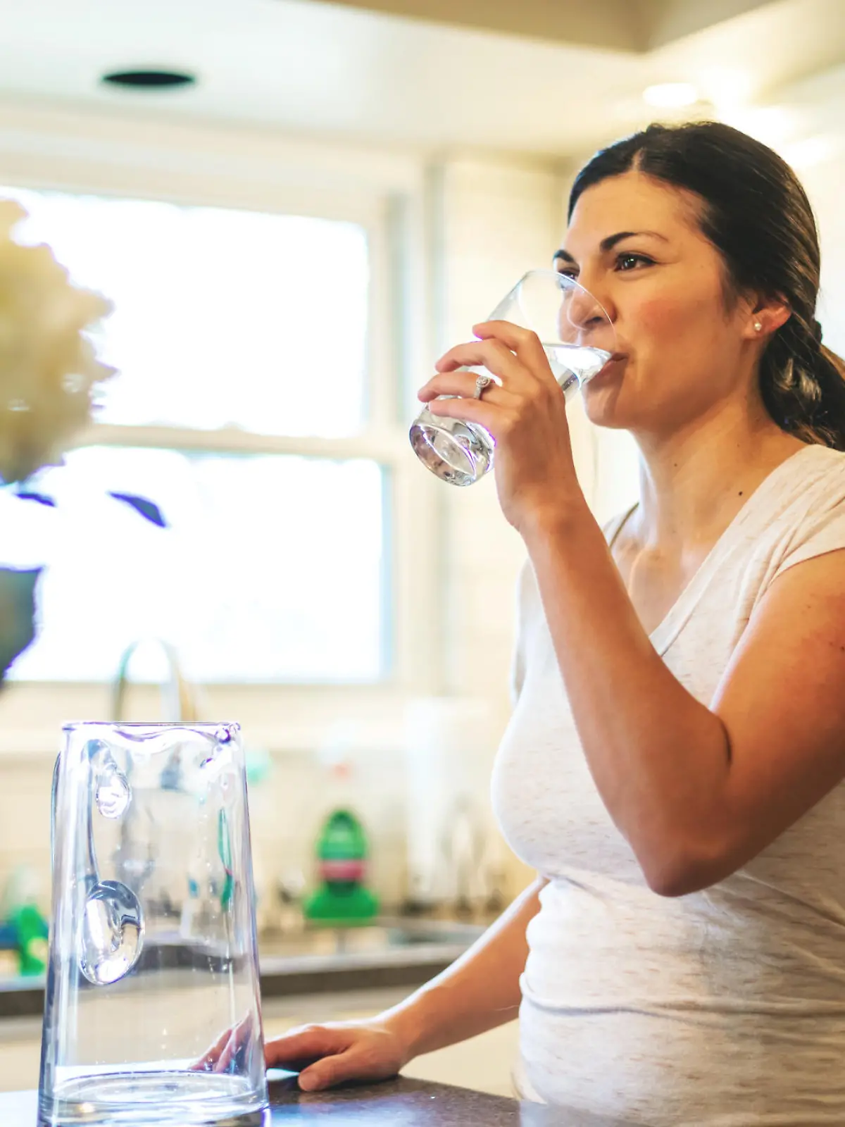 Beautiful Young Adult Filipino Millennial Female using water in residential home (Shot with Canon 5DS 50.6mp photos professionally retouched - Lightroom / Photoshop - original size 5792 x 8688 downsampled as needed for clarity and select focus used for dramatic effect)