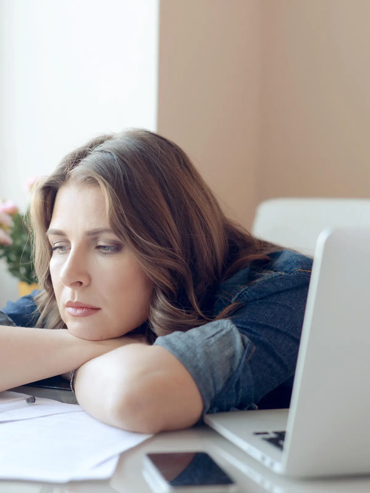 young beautiful woman sitting at the table and working at home