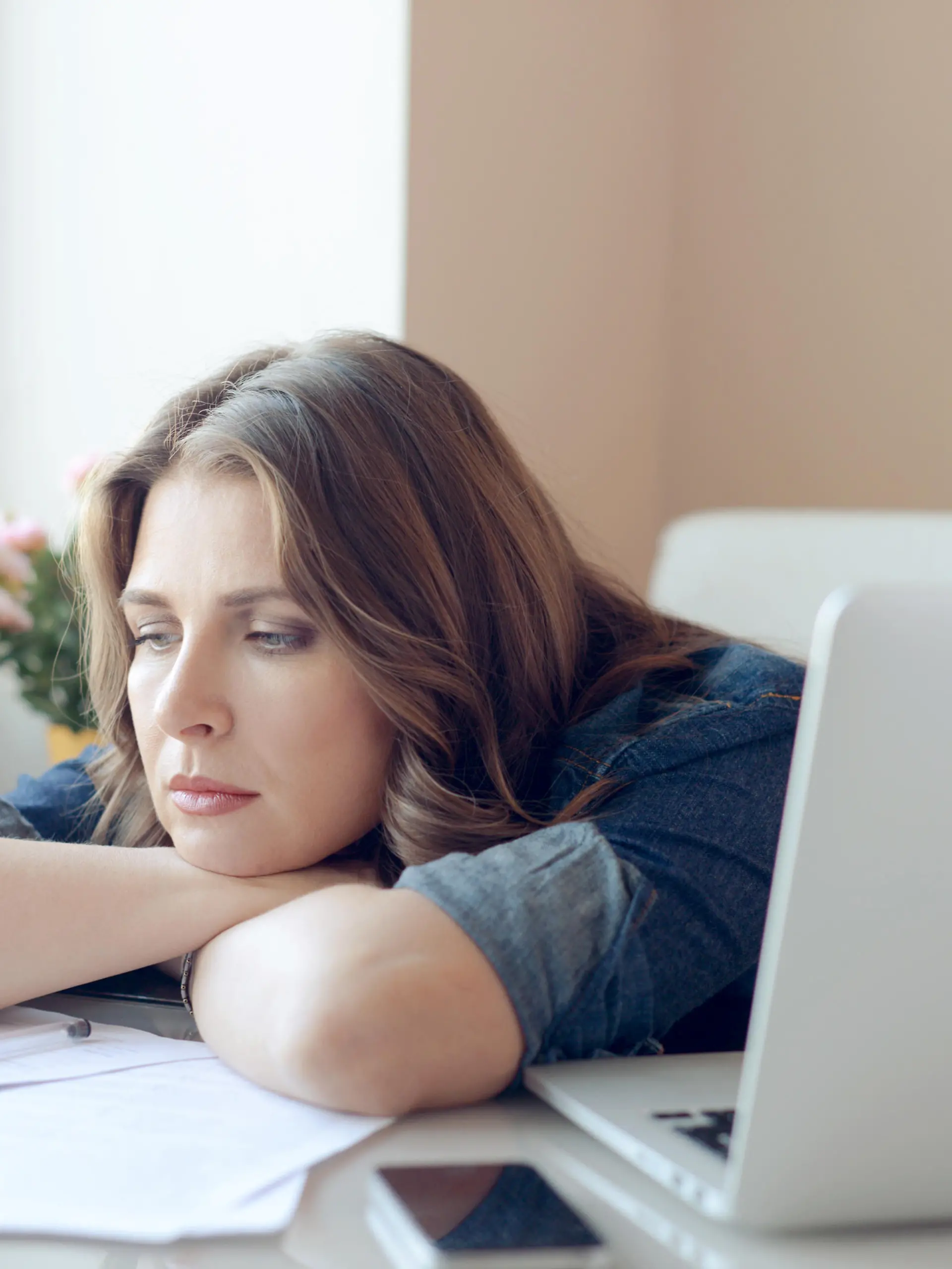 young beautiful woman sitting at the table and working at home