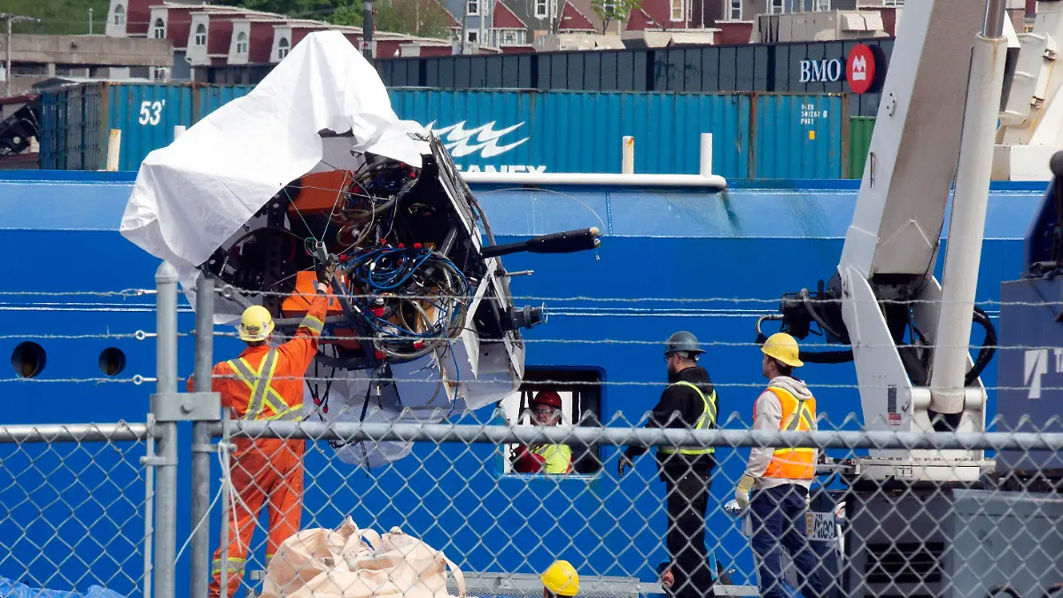 FILE - Debris from the Titan submersible, recovered from the ocean floor near the wreck of the Titanic, is unloaded from the ship Horizon Arctic at the Canadian Coast Guard pier in St. John's, Newfoundland, Wednesday, June 28, 2023. OceanGate, the company that owned a submersible that imploded on its way to explore the wreck of the Titanic, killing all five onboard, said Thursday, July 6, that it has suspended operations. (Paul Daly/The Canadian Press via AP, File)