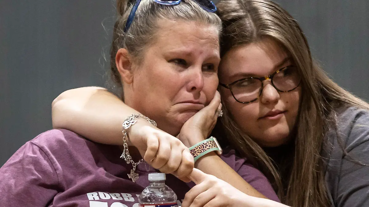 Nicole Ogburn is comforted by her 17-year-old daughter Trinity Ogburn during a vigil held in honor of the lives lost at Robb Elementary the day before at the Uvalde County Fairplex Arena in Uvalde, Texas, Wednesday, May 25, 2022.. (Josie Norris/The San Antonio Express-News via AP)