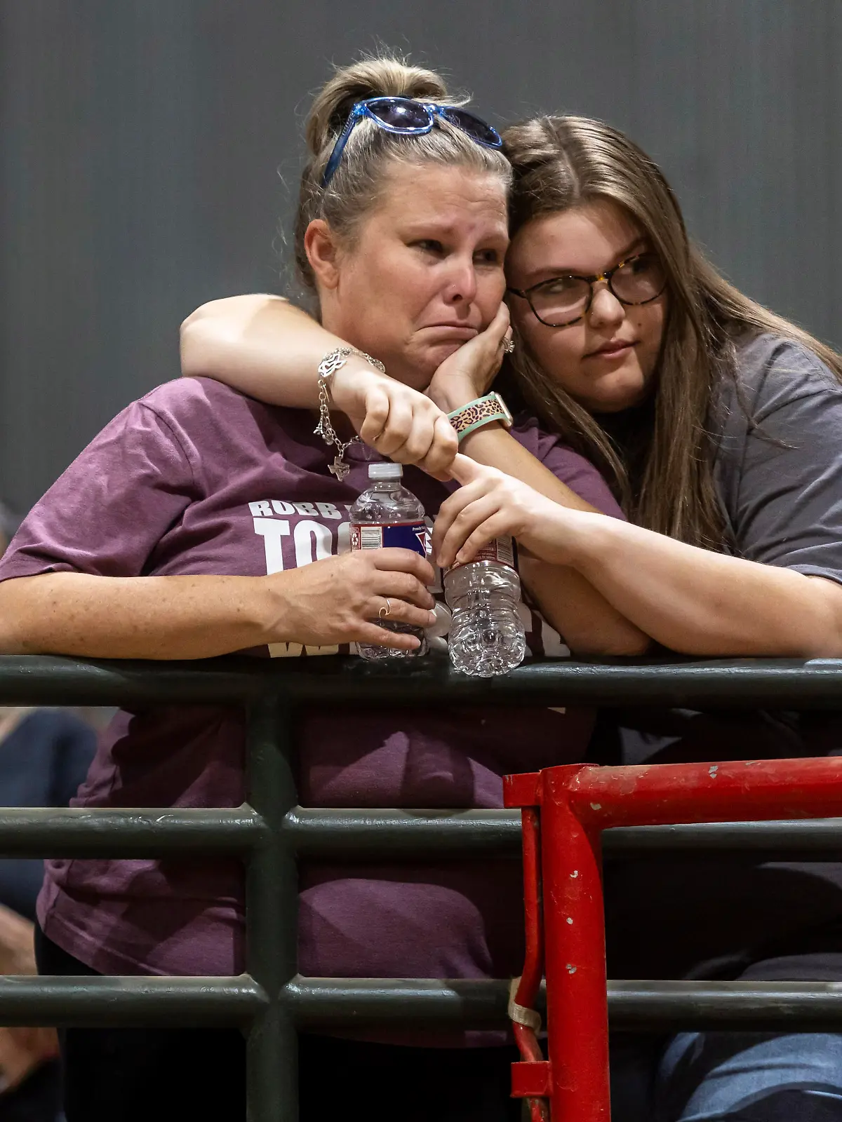 Nicole Ogburn is comforted by her 17-year-old daughter Trinity Ogburn during a vigil held in honor of the lives lost at Robb Elementary the day before at the Uvalde County Fairplex Arena in Uvalde, Texas, Wednesday, May 25, 2022.. (Josie Norris/The San Antonio Express-News via AP)