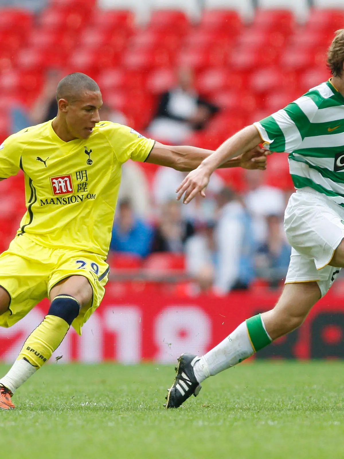 Tottenham Hotspur's Jake Livermure, left, competes with Celtic's Paddy McCourt during their Wembley Cup soccer match at Wembley Stadium, London, Sunday, July 26, 2009. (AP Photo/Sang Tan)