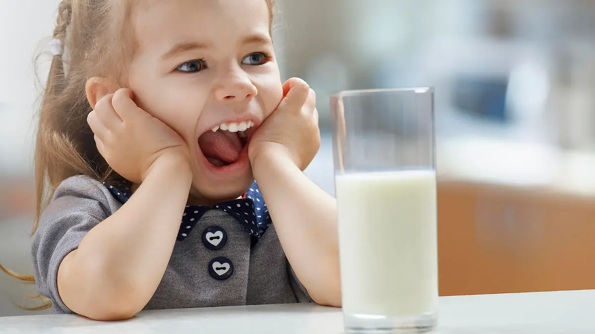 girl drinking milk at the kitchen