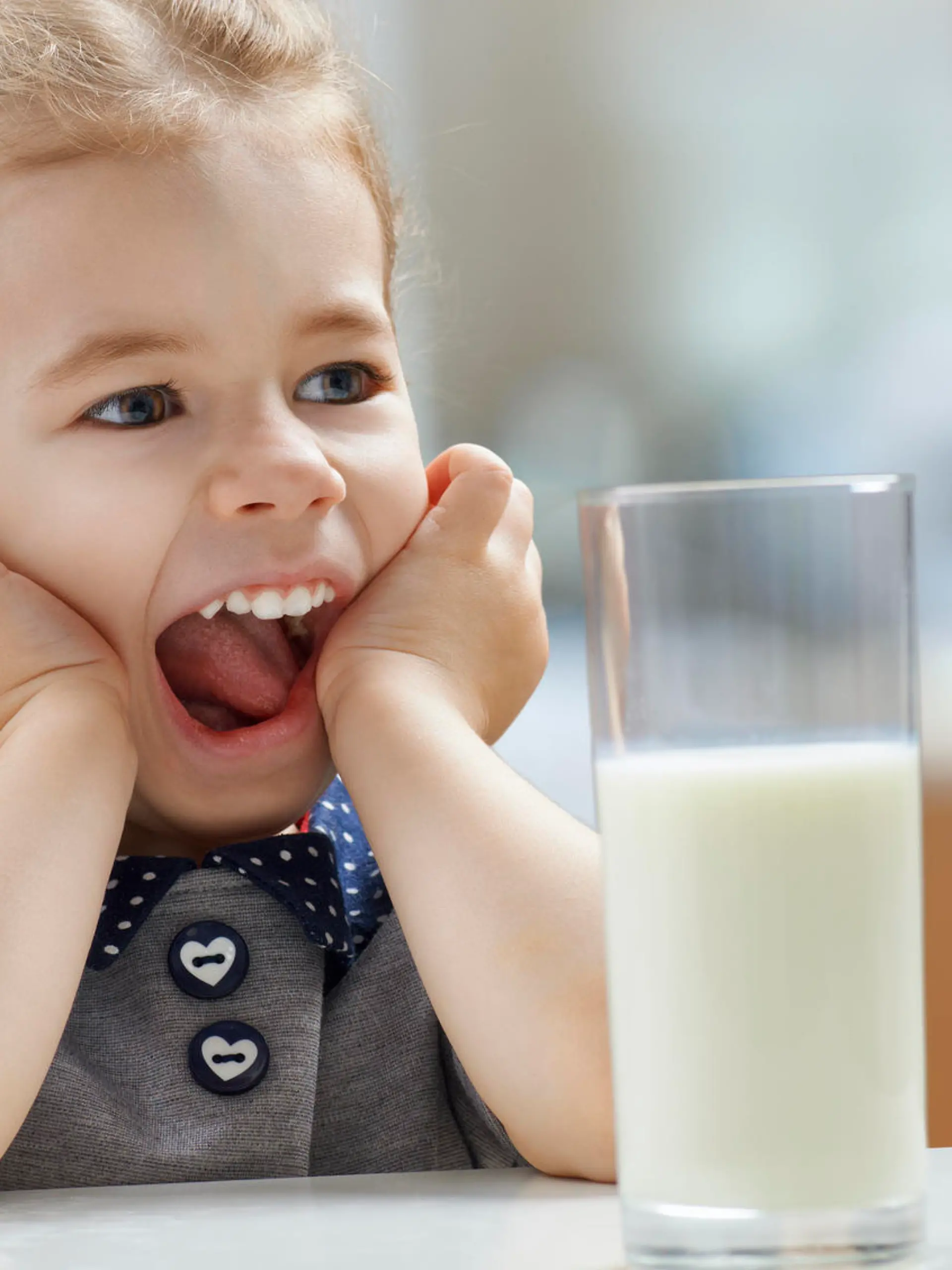 girl drinking milk at the kitchen