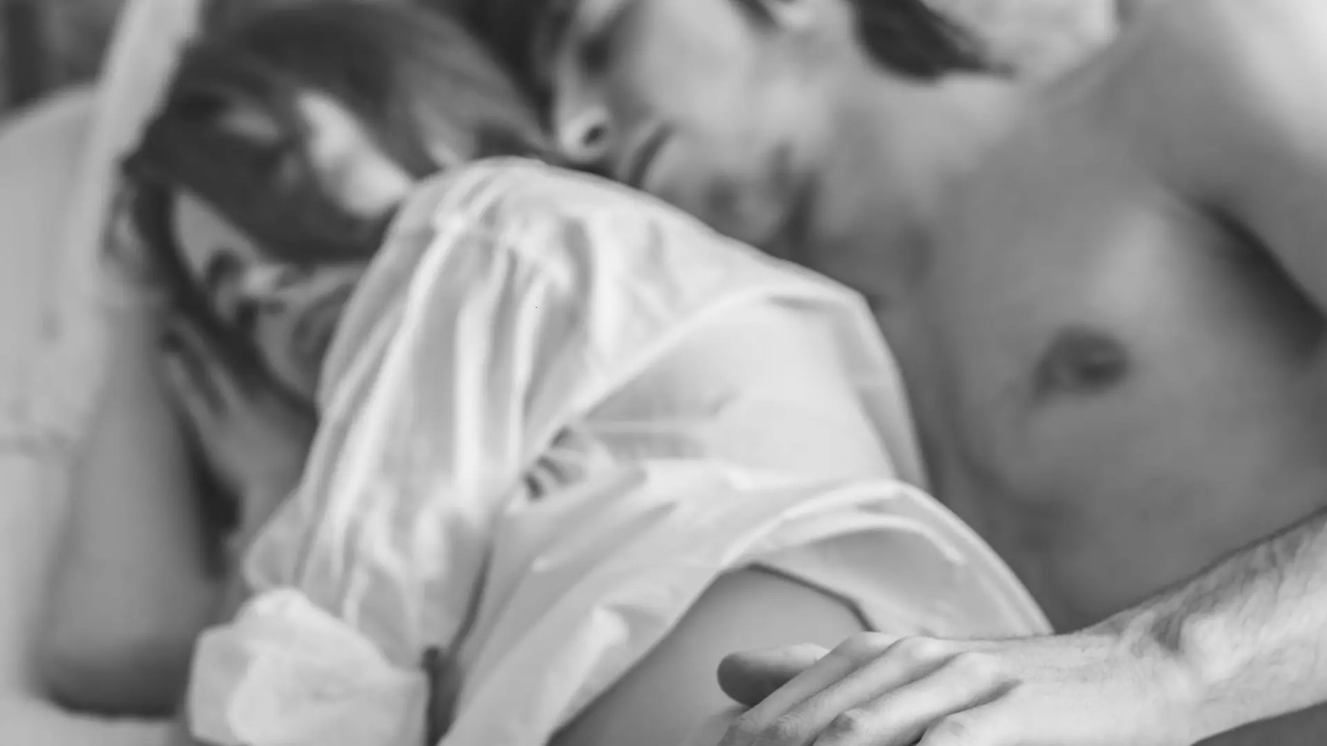 couple of young people having sex, they lie on the bed, hugging each other