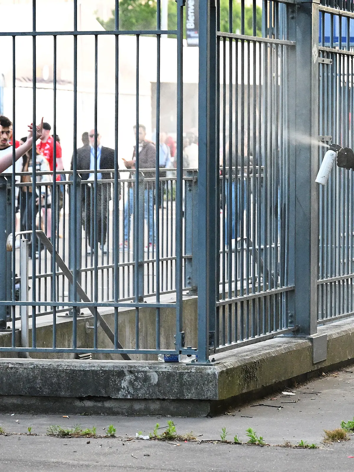 PARIS, FRANCE - MAY 28: Police spray tear gas at Liverpool fans outside the stadium as they queue prior to the UEFA Champions League final match between Liverpool FC and Real Madrid at Stade de France on May 28, 2022 in Paris, France. (Photo by Matthias Hangst/Getty Images)