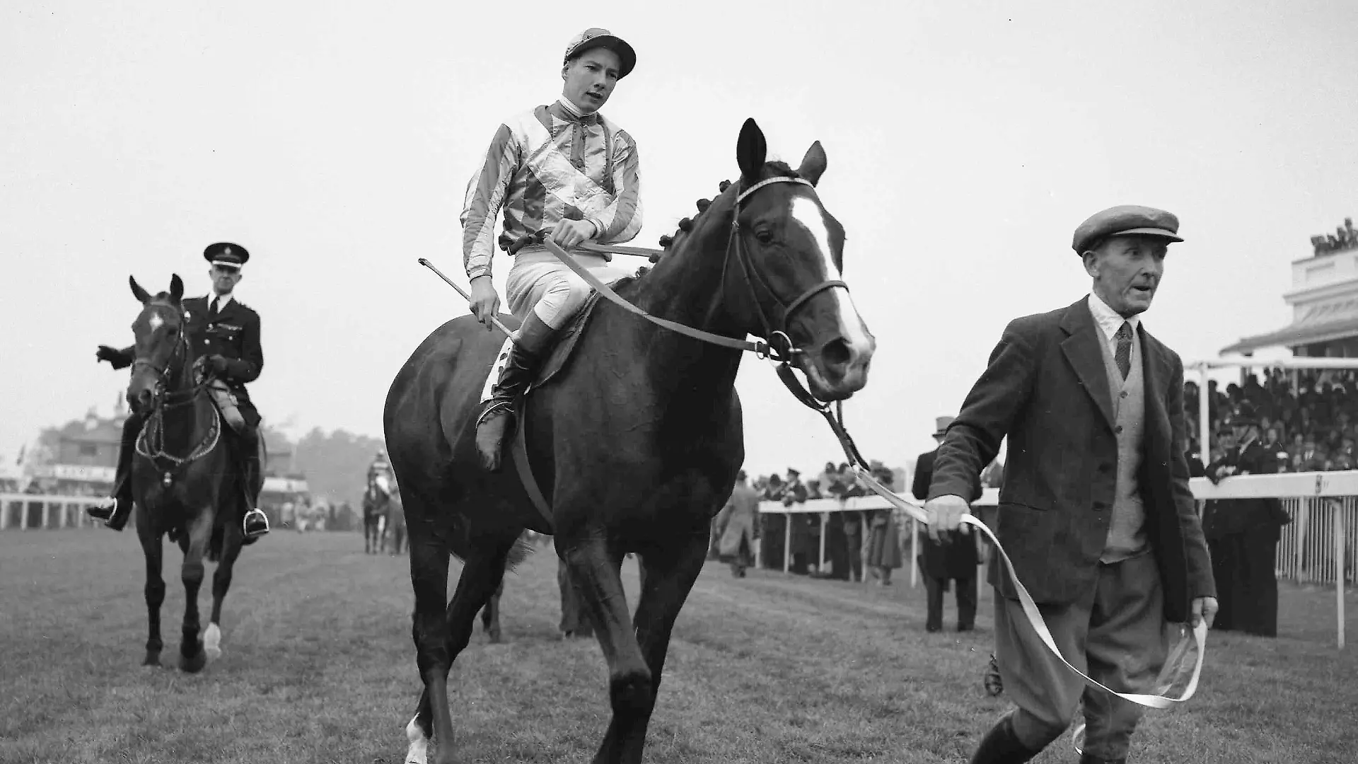 FILE - British jockey Lester Piggott on Never Say Die, is led into the winners enclosure at Epsom, England, June 2, 1954, after winning the Derby. English jockey great Lester Piggott has died at the age of 86, it was announced on Sunday, May 29, 2022. He won the English Derby nine times in his haul of victories in horse racing’s top events and will be remembered for being one of the greatest jockeys of all time. (AP Photo, File)