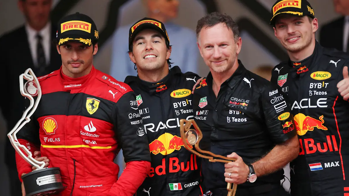 From left, second place Ferrari driver Carlos Sainz of Spain, winner Red Bull driver Sergio Perez of Mexico , Team chief Christian Horner of Red Bull Racing and third placed Red Bull driver Max Verstappen of the Netherlands celebrate on the podium of the Monaco Formula One Grand Prix, at the Monaco racetrack, in Monaco, Sunday, May 29, 2022. (AP Photo/Daniel Cole)