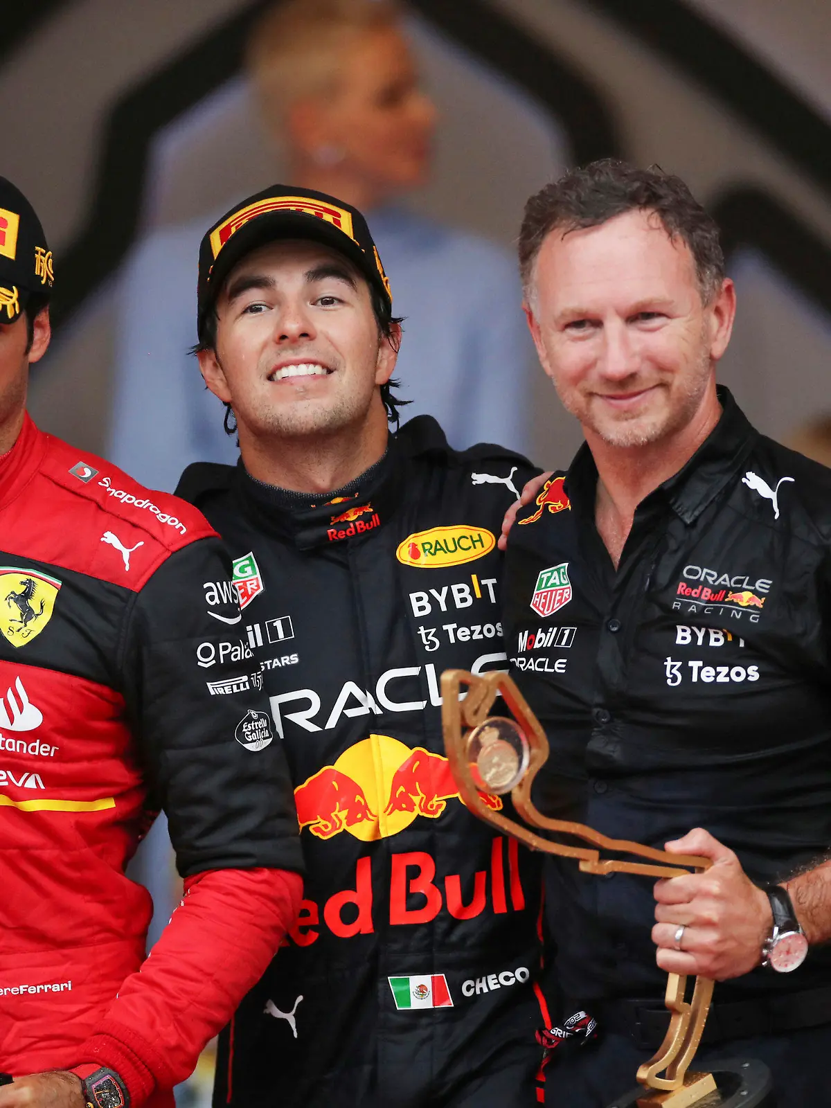 From left, second place Ferrari driver Carlos Sainz of Spain, winner Red Bull driver Sergio Perez of Mexico , Team chief Christian Horner of Red Bull Racing and third placed Red Bull driver Max Verstappen of the Netherlands celebrate on the podium of the Monaco Formula One Grand Prix, at the Monaco racetrack, in Monaco, Sunday, May 29, 2022. (AP Photo/Daniel Cole)