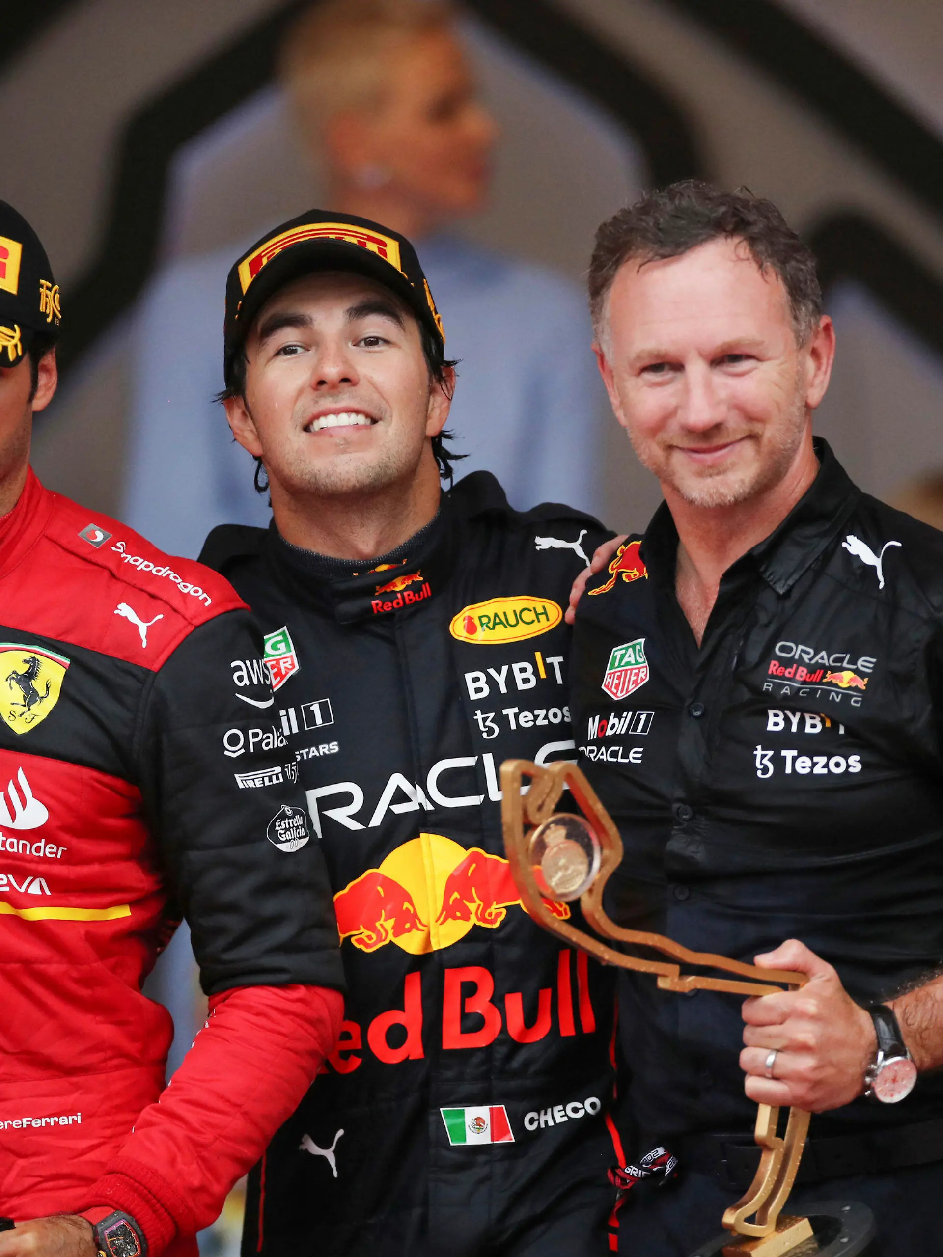 From left, second place Ferrari driver Carlos Sainz of Spain, winner Red Bull driver Sergio Perez of Mexico , Team chief Christian Horner of Red Bull Racing and third placed Red Bull driver Max Verstappen of the Netherlands celebrate on the podium of the Monaco Formula One Grand Prix, at the Monaco racetrack, in Monaco, Sunday, May 29, 2022. (AP Photo/Daniel Cole)