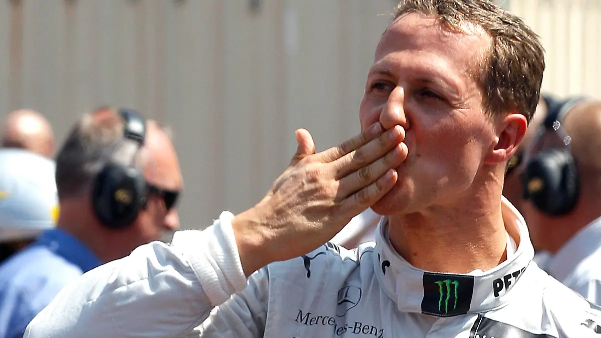 Mercedes Formula One driver Michael Schumacher of Germany celebrates being the fastest in qualifying at the Monaco F1 Grand Prix May 26, 2012. Schumacher's departure from the Mercedes Formula One team was sealed on September 28, 2012 after the seven-times world champion recorded only one podium finish since his comeback in 2010. Schumacher, 43, the sport's most successful driver with a record 91 Grand Prix victories, will be replaced in 2013 by Lewis Hamilton, who has signed a three-year deal with the British-based team. Picture taken May 26, 2012. REUTERS/Max Rossi/Files  (MONACO - Tags: SPORT MOTORSPORT F1)