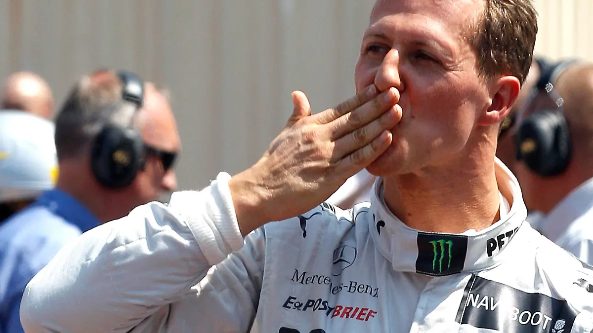 Mercedes Formula One driver Michael Schumacher of Germany celebrates being the fastest in qualifying at the Monaco F1 Grand Prix May 26, 2012. Australian Mark Webber will start Sunday's Monaco Grand Prix on pole position for Red Bull after Schumacher set the pace in qualifying but was subject to a five place grid penalty. REUTERS/Max Rossi    (MONACO - Tags: SPORT MOTORSPORT)