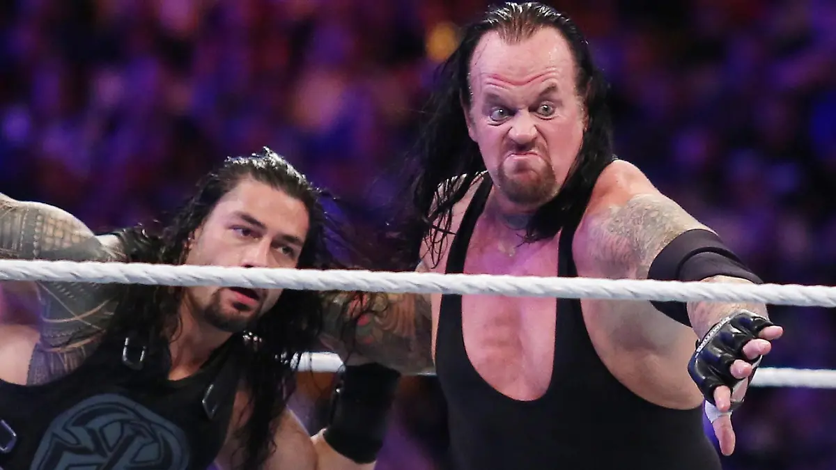 The Undertaker, right, throws Roman Reigns during WrestleMania 33 at Camping World Stadium in Orlando in 2017. Reigns pulled out of this year's WrestleMania, which took place March 25 and 26 at the WWE Performance Center, but Undertaker is still scheduled to wrestle A.J. Styles at the show, which will air April 4 and 5. (Stephen M. Dowell/Orlando Sentinel/TNS) Photo via Newscom picture alliance