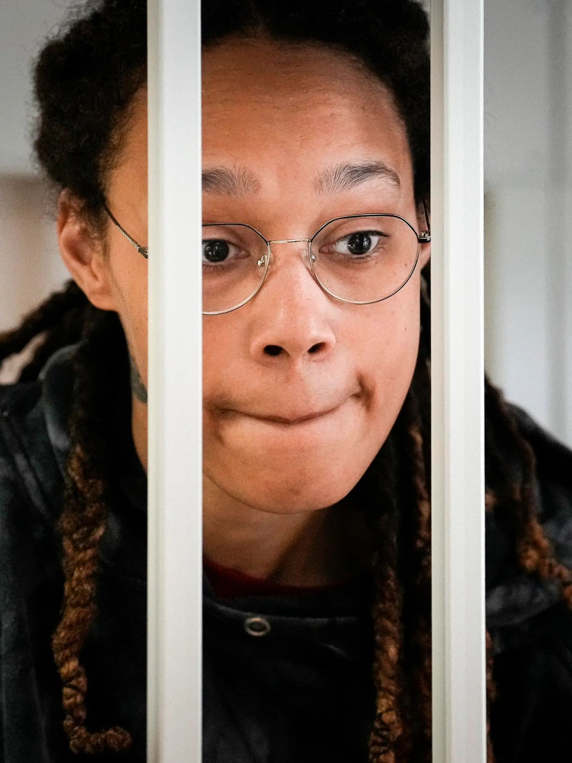 FILE - WNBA star and two-time Olympic gold medalist Brittney Griner speaks to her lawyers standing in a cage at a court room prior to a hearing, in Khimki just outside Moscow, Russia, on July 26, 2022.  Russia has freed WNBA star Brittney Griner on Thursday in a dramatic high-level prisoner exchange, with the U.S. releasing notorious Russian arms dealer Viktor Bout. (AP Photo/Alexander Zemlianichenko, Pool, File)