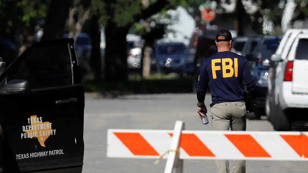 A member of the FBI walks outside Robb Elementary school, two days after a gunman killed nineteen children and two adults, in Uvalde, Texas, U.S. May 26, 2022. REUTERS/Marco Bello