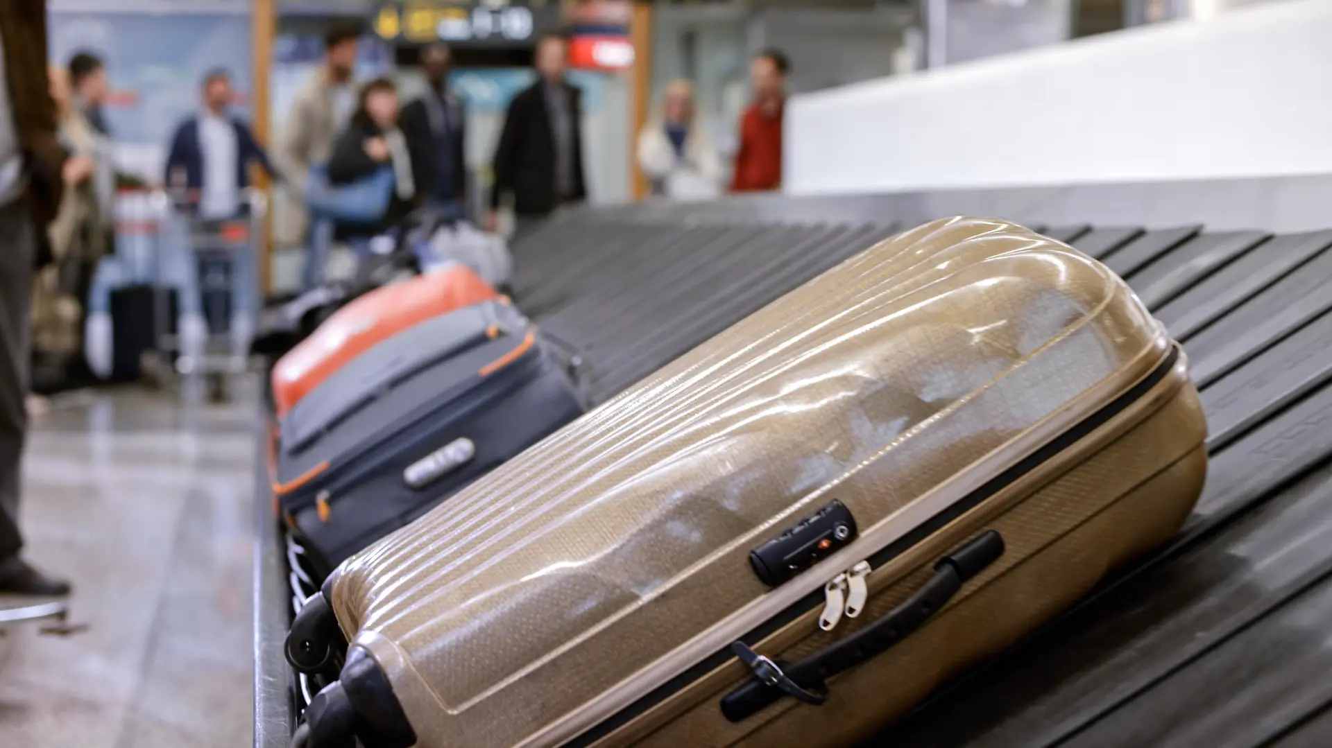 Business people standing at baggage claim in airport.