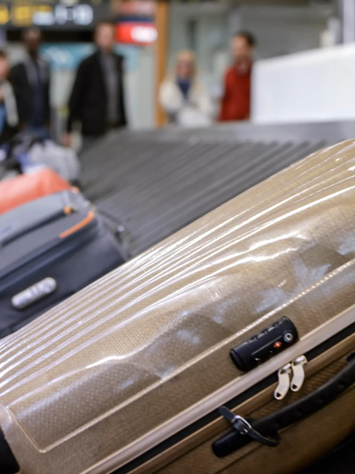 Business people standing at baggage claim in airport.
