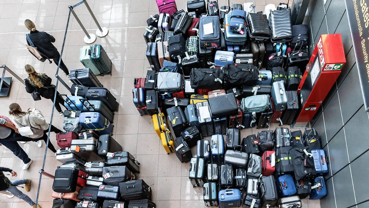 05.05.2024, Hamburg: Fluggepäck liegt an einem Sammelpunkt in einer Abflughalle des Flughafens Hamburg. Wegen eines Ausfalls der Gepäckanlage muss das Fluggepäck von Hand sortiert und dann zu den Maschinen gebracht werden. Foto: Markus Scholz/dpa +++ dpa-Bildfunk +++