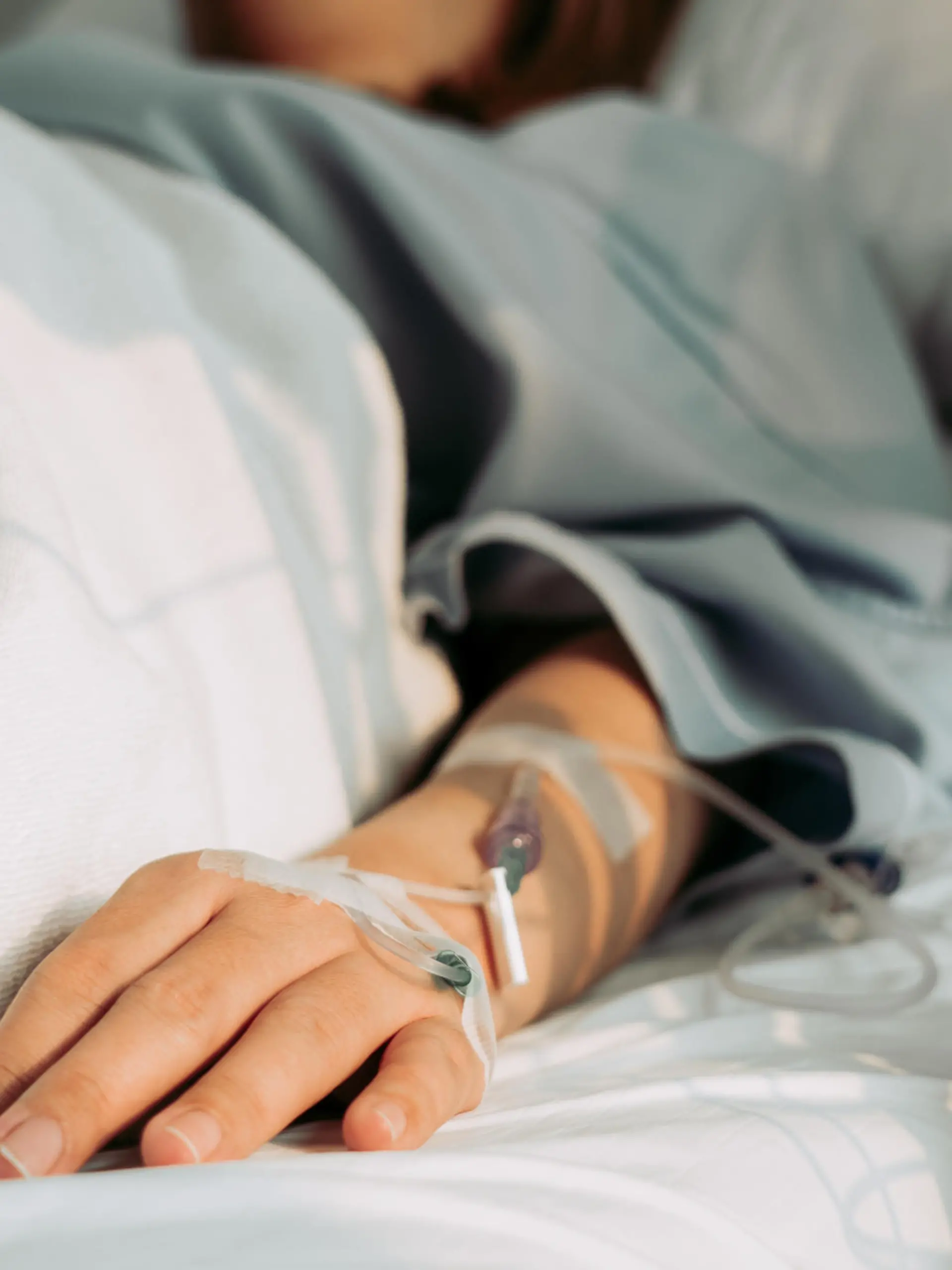 Asian woman lying sick in hospital.