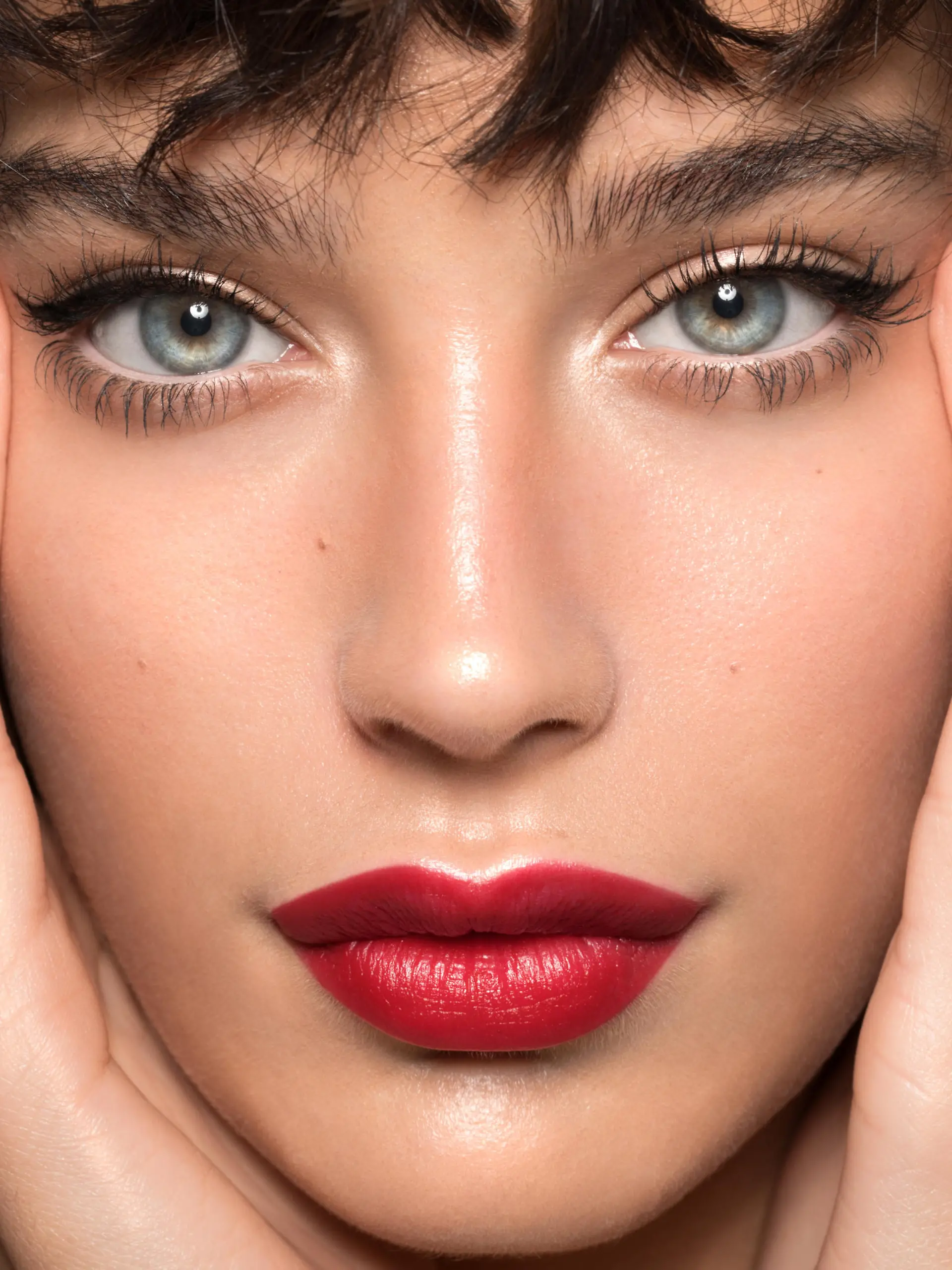 Close up studio shot of a beautiful woman with perfect skin, she touching her face