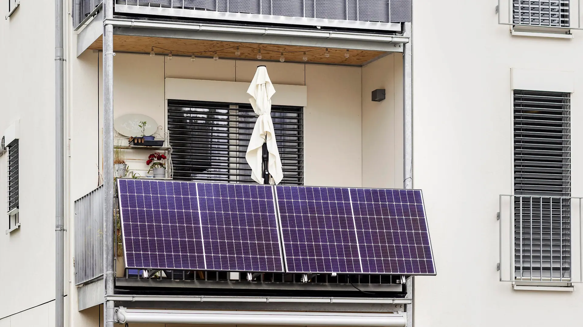 Balcony Solar Panels. Modern Mini Solar Panel System on Balcony of Apartment Building in City. Green Power Energy of Modern Flat.