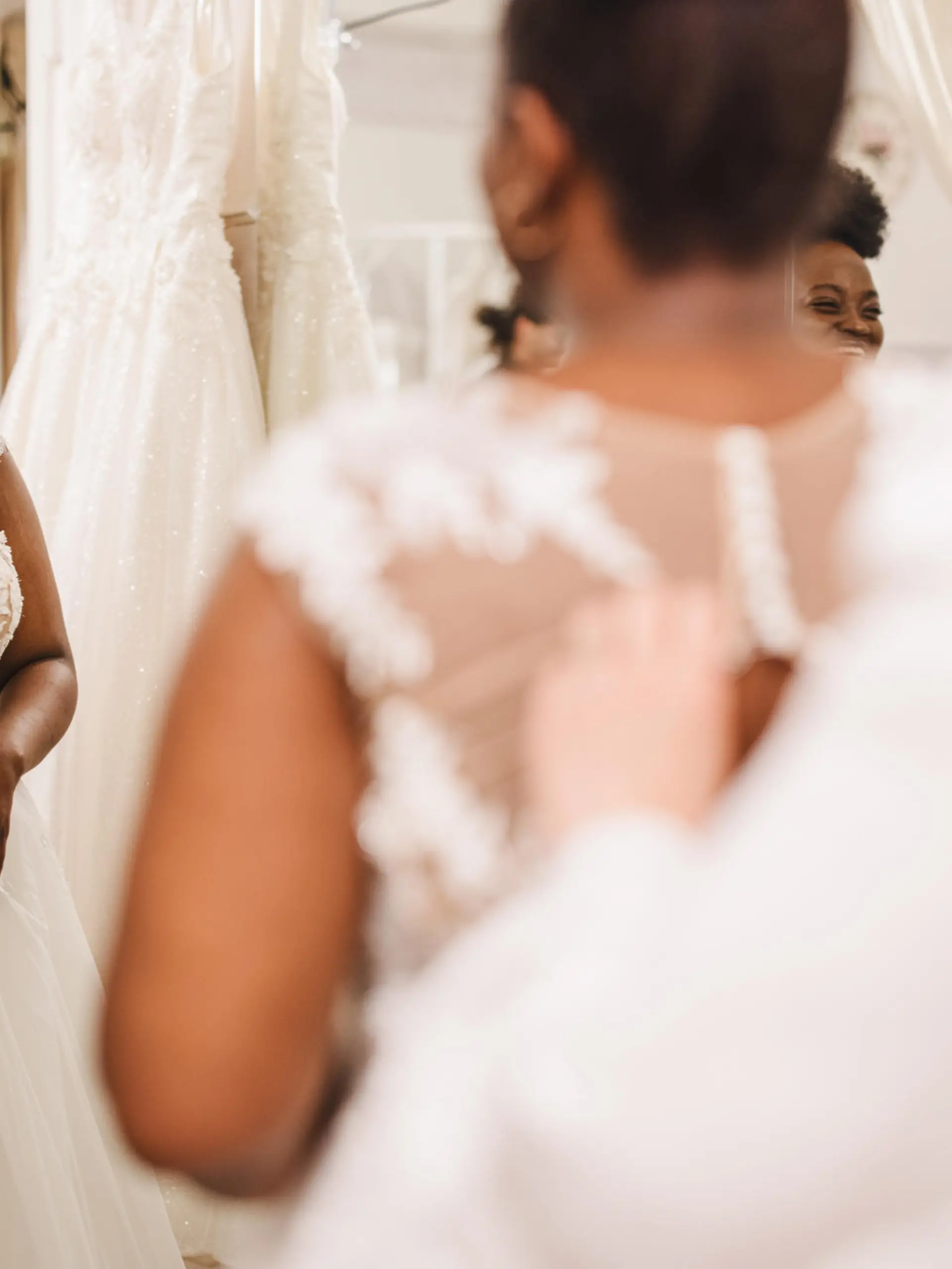 The future bride looks around the shop and tries on wedding dresses in the presence of her best friends. Lifestyle shopping concept, post-Covid-19 era