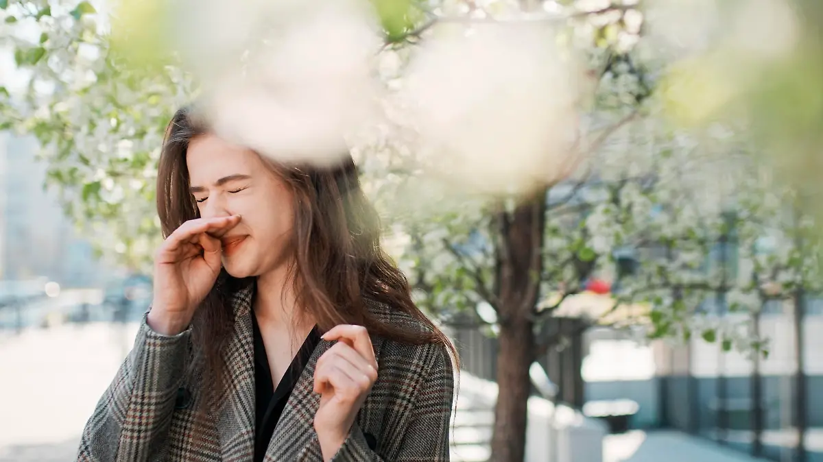 Woman struggling with allergy. Itchy eyes and sneezing