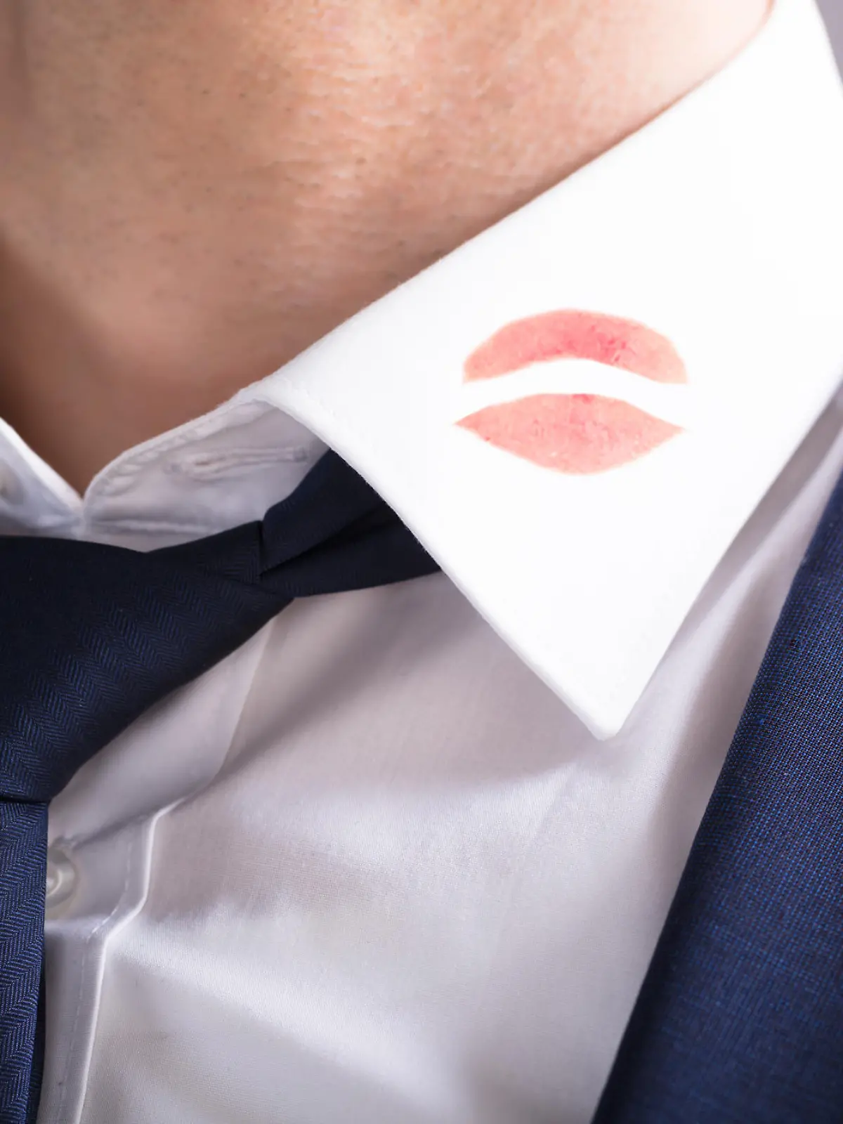 Close-up Of A Businessman With Lipstick Kiss Marks On Shirt's Collar