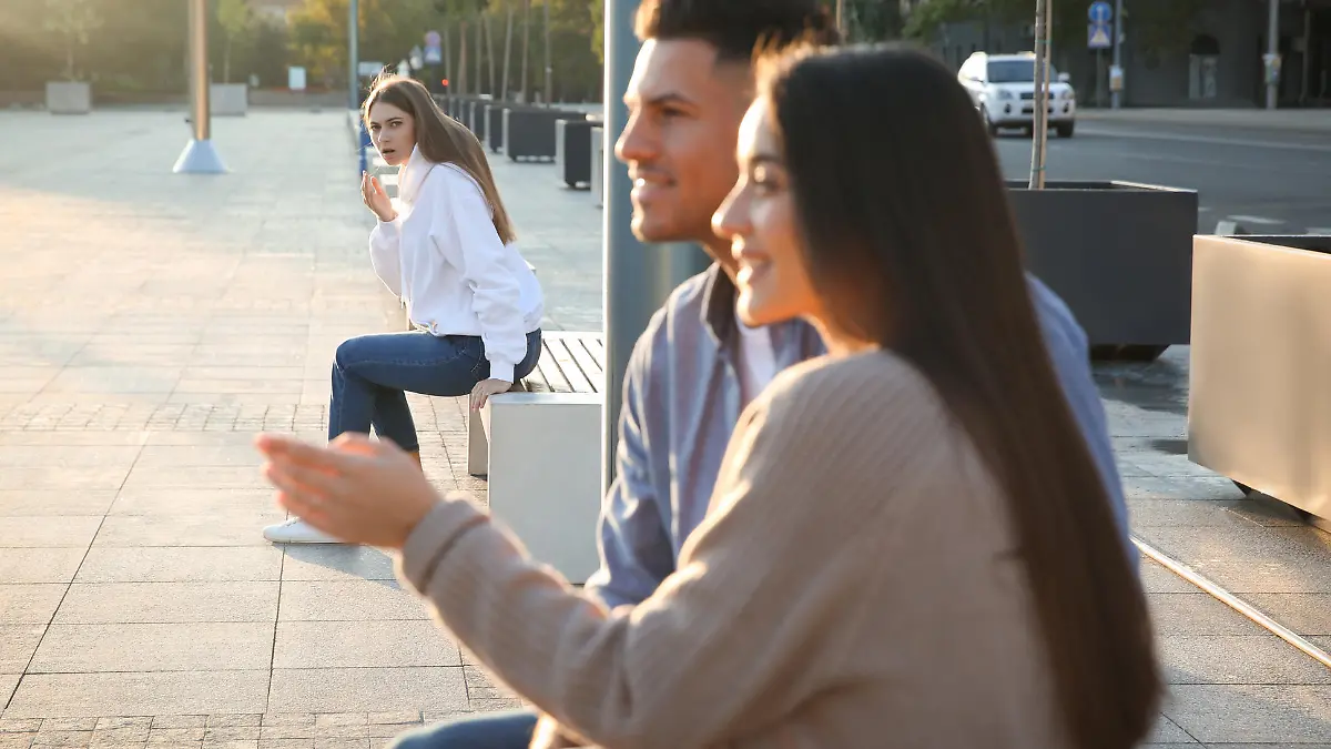 Jealous ex girlfriend spying on couple outdoors