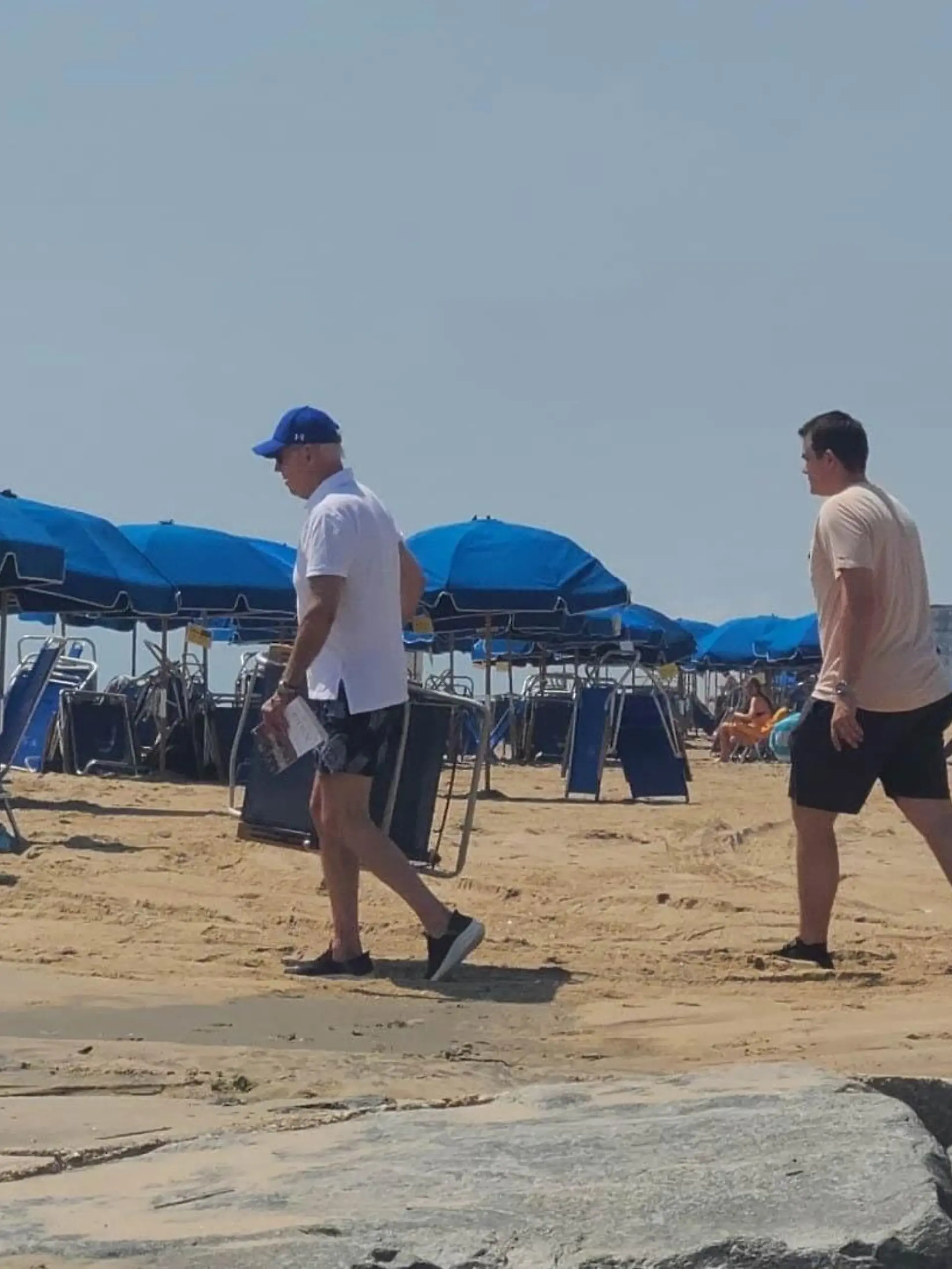 SONDERKONDITIONEN: MINDESTHONORAR: *EXCLUSIVE* - 
President Biden's got a busy week ahead of him with a planned trip to Europe -- but before he gets back on the job .. it looks like he wanted to kick up his feet, and some sand too.
JB was in Rehoboth Beach, DE Saturday -- where he and FLOTUS, Jill Biden, have a summer home in the North Shores neighborhood -- and both of them went down toward the shore to soak in some rays and enjoy the atmosphere .. a very sunny one, indeed.
Now, eyewitnesses tell us it was Jill who actually arrived on the beach first -- accompanied by a bunch of Secret Service agents -- and that Joe eventually followed with his own flock.
As you can see, the Bidens had chairs and umbrellas laid out .. and Jill even threw on some sunscreen for protection. When it comes to Joe -- he settled for a baseball cap and keeping his shirt on. Shoes, too, it seems .. you can never be too careful for POTUS!
When they were finally seated next to each other .. we're told Joe was busy reading a bunch of papers, although it's unclear what was on them. No PDA between the first couple or anything -- sounds like they were just content with being in each other's company.
Anyway, like we said .. Joe's scheduled to hit the skies Sunday for a 5-day trip overseas, where he'll touch down in England, Lithuania and Finland for a handful of engagements.
It's interesting he's gonna be out of town this week, seeing how the findings of the ongoing cocaine probe are expected to be released in the coming days. Remember, an undisclosed amount of the illicit substance was found in the West Wing over 4th of July weekend.
Seeing how he'll be out of the country through at least Friday, something tells us the Prez won't be taking any questions about it anytime soon .. even if the intrigue is far from over.
**MANDATORY CREDIT: TMZ/BACKGRID**
Pictured: Joe BIden
BACKGRID USA 9 JULY 2023 
BYLINE MUST READ: TMZ / BACKGRID
**USA and Canada Clients Must Call for Rights**


