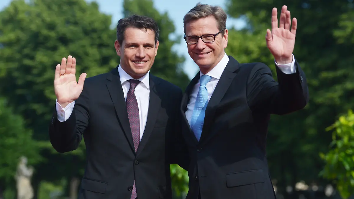 CORRECTING THE PHOTOGRAPHERS NAME-German Foreign Minister Guido Westerwelle (R) and his partner Michael Mronz pose upon arrival for a state dinner for the US president in Berlin, on June 19, 2013. US President Barack Obama walks in John F. Kennedy's footsteps on his first visit to Berlin as US president, but encounters a more powerful and sceptical Germany in talks on trade and secret surveillance practices. AFP PHOTO / OLIVER LANG (Photo credit should read OLIVER LANG/AFP/Getty Images)