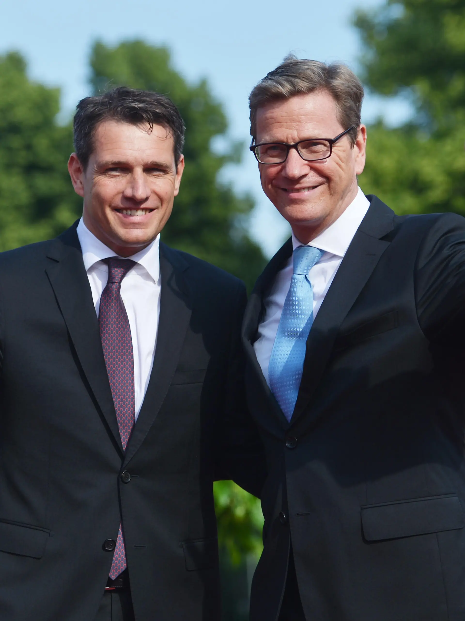 CORRECTING THE PHOTOGRAPHERS NAME-German Foreign Minister Guido Westerwelle (R) and his partner Michael Mronz pose upon arrival for a state dinner for the US president in Berlin, on June 19, 2013. US President Barack Obama walks in John F. Kennedy's footsteps on his first visit to Berlin as US president, but encounters a more powerful and sceptical Germany in talks on trade and secret surveillance practices.   AFP PHOTO / OLIVER LANG        (Photo credit should read OLIVER LANG/AFP/Getty Images)